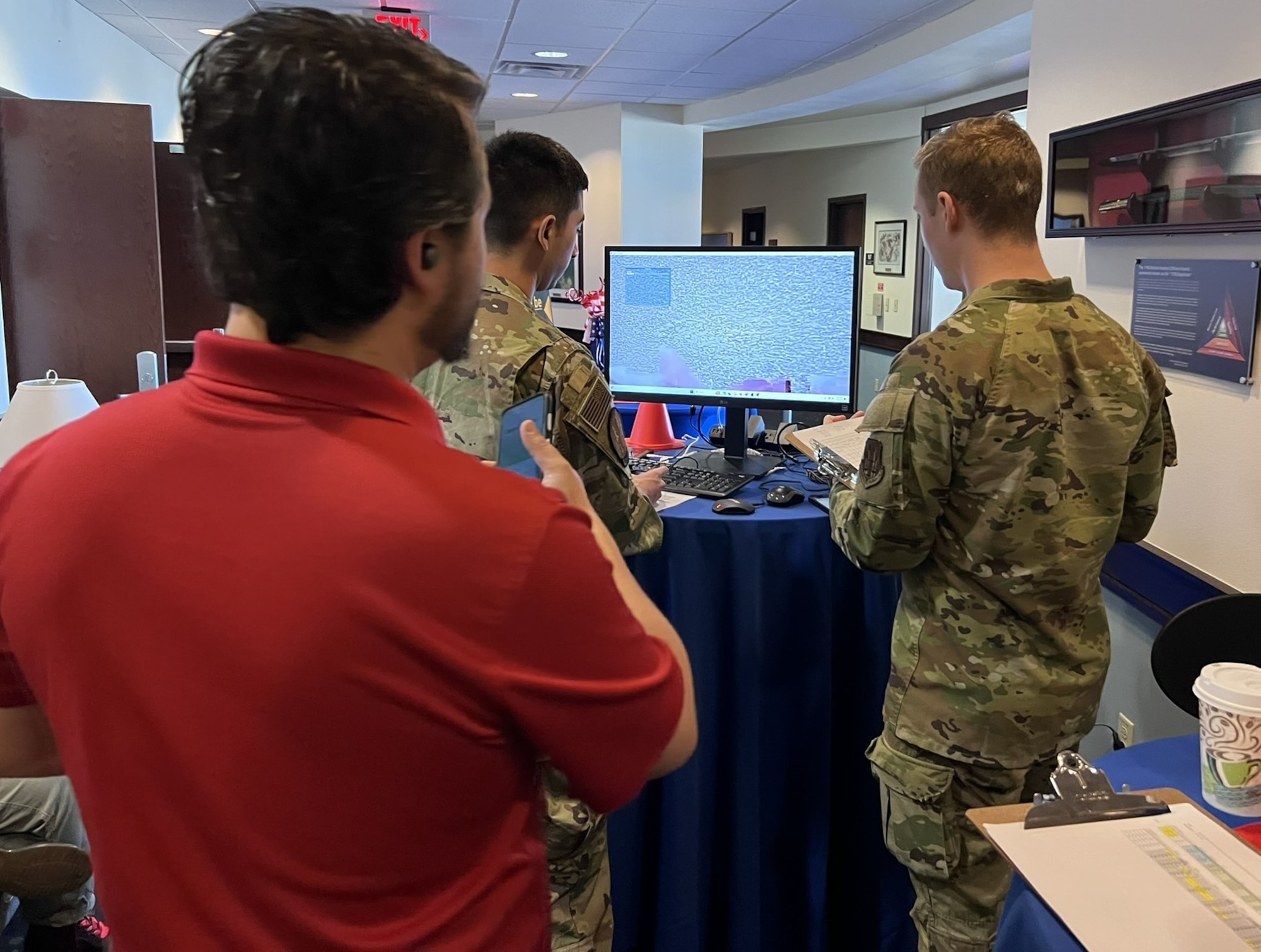 AFOTEC 401 students, overseen by a course instructor, remotely pilot the Rover Revolution drone in an outdoor test range to practice data collection and troubleshooting of a live system.