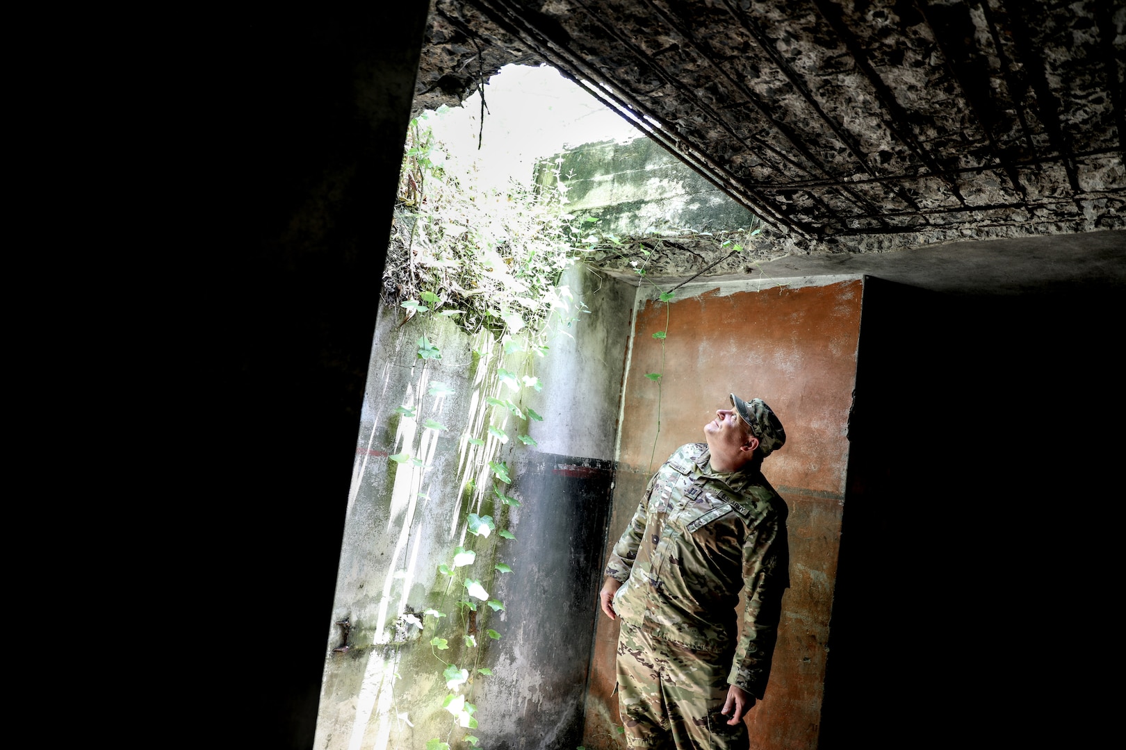 Capt. Florian Waitl, the Wisconsin Army National Guard command historian, inspects a World War II fighting position March 19 during a recent visit to Papua New Guinea. He was among 40 Wisconsin National Guard Airmen and Soldiers to spend the week of March 17-22 in Papua New Guinea collaborating with and training alongside the Papua New Guinea Defence Force as part of the State Partnership Program. This current exchange includes meetings between leadership along with training in instruction, medical, security forces, and collaboration with senior non-commissioned officers. The Wisconsin National Guard and Papua New Guinea began their partnership in 2020 and have since had several key leader engagements and site visits to strengthen that relationship. Wisconsin National Guard photo by Staff Sgt. Kati Volkman