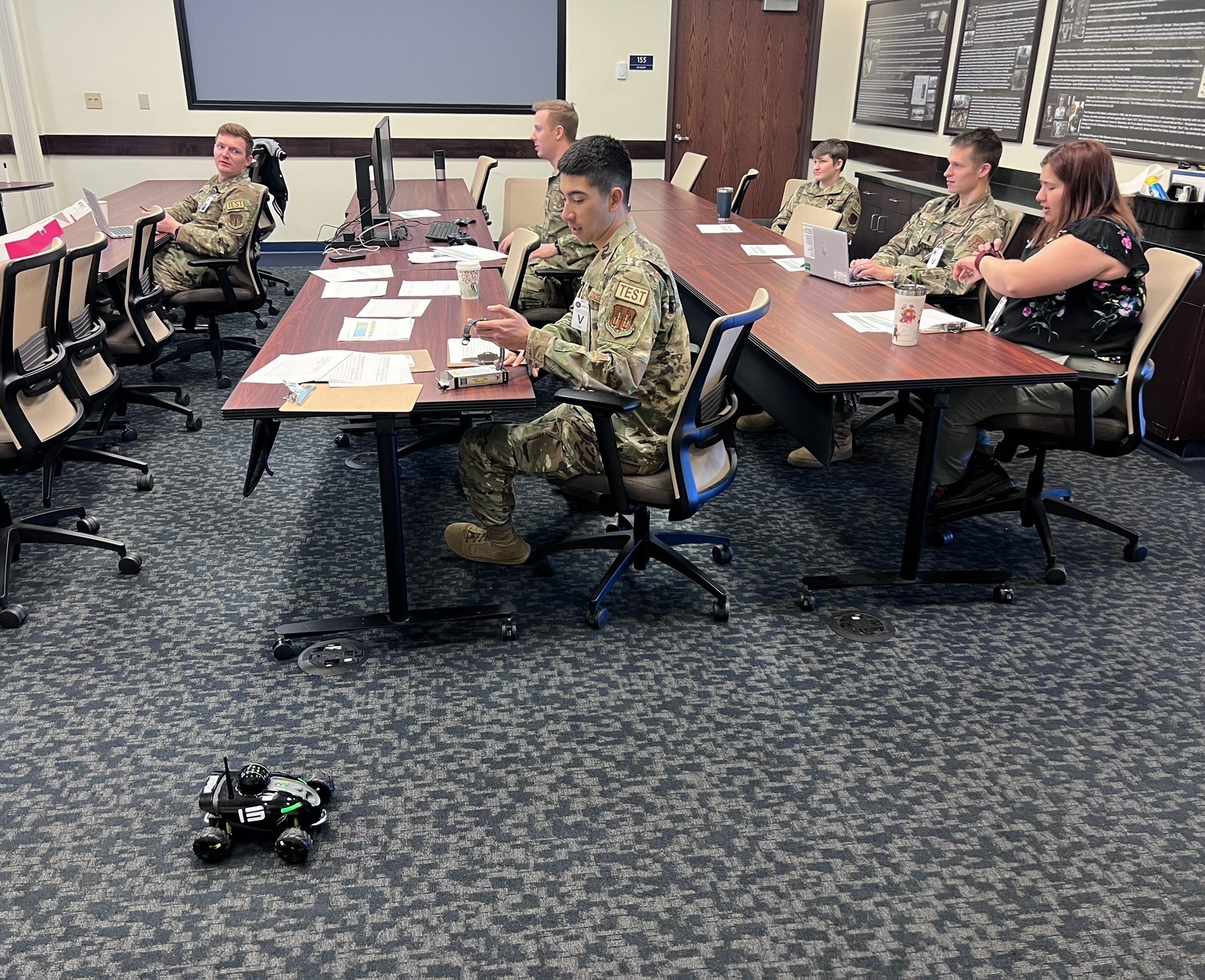AFOTEC 401 students prepare data collection and timing devices for indoor test range runs of the Rover Revolution.