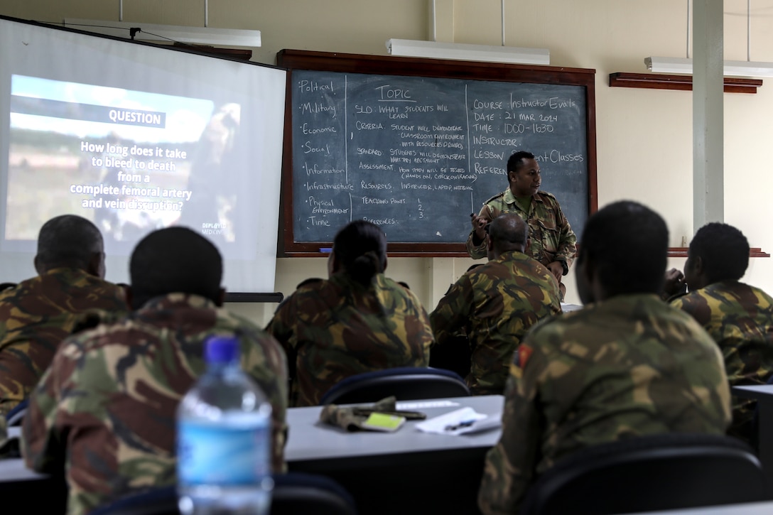 Cpl. David Oata, a medic with the Papua New Guinea Defence Force, demonstrates his instructor skills by teaching a class on the history of the tourniquet March 21 during a recent visit by 40 Wisconsin National Guard members to Papua New Guinea in support of the State Partnership Program. This current exchange includes meetings between leadership along with training in instruction, medical, security forces, and collaboration with senior non-commissioned officers. The Wisconsin National Guard and Papua New Guinea began their partnership in 2020 and have since had several key leader engagements and site visits to strengthen that relationship. Wisconsin National Guard photo by Staff Sgt. Kati Volkman