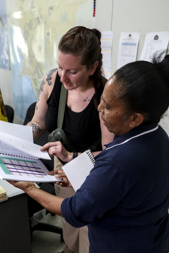 Sgt. 1st Class Lindsey Breivogel, a master resilience trainer course manager with the Wisconsin National Guard’s 426th Regional Training Institute, reviews Papua New Guinea Defence Force training documents with Maj. Louisa Wanma, the PNGDF military hospital’s second-in-command and a medical lab scientific officer, March 17 during a recent visit by 40 Wisconsin National Guard members to Papua New Guinea in support of the State Partnership Program. This current exchange includes meetings between leadership along with training in instruction, medical, security forces, and collaboration with senior non-commissioned officers. The Wisconsin National Guard and Papua New Guinea began their partnership in 2020 and have since had several key leader engagements and site visits to strengthen that relationship. Wisconsin National Guard photo by Staff Sgt. Kati Volkman