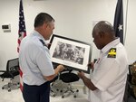 Maj. Gen. Paul Knapp, Wisconsin’s adjutant general, presents Commodore Philip Polewara, acting defence chief of the Papua New Guinea Defence Force, with a framed print March 18 of an interaction between Soldiers of the 32nd Division and a Papua New Guinean sketching a diagram of Japanese military positions from Nov. 15, 1942 during the campaign to drive the Japanese army out of Buna. The 32nd Division was largely composed of Wisconsin National Guard Soldiers when World War II began. The photo underscores how far back Wisconsin’s history goes with Papua New Guinea. Forty Wisconsin National Guard Airmen and Soldiers spent the week of March 17-22 in Papua New Guinea collaborating with and training alongside the Papua New Guinea Defence Force as part of the State Partnership Program. This current exchange includes meetings between leadership along with training in instruction, medical, security forces, and collaboration with senior non-commissioned officers. The Wisconsin National Guard and Papua New Guinea began their partnership in 2020 and have since had several key leader engagements and site visits to strengthen that relationship. Wisconsin National Guard photo by Staff Sgt. Kati Volkman
