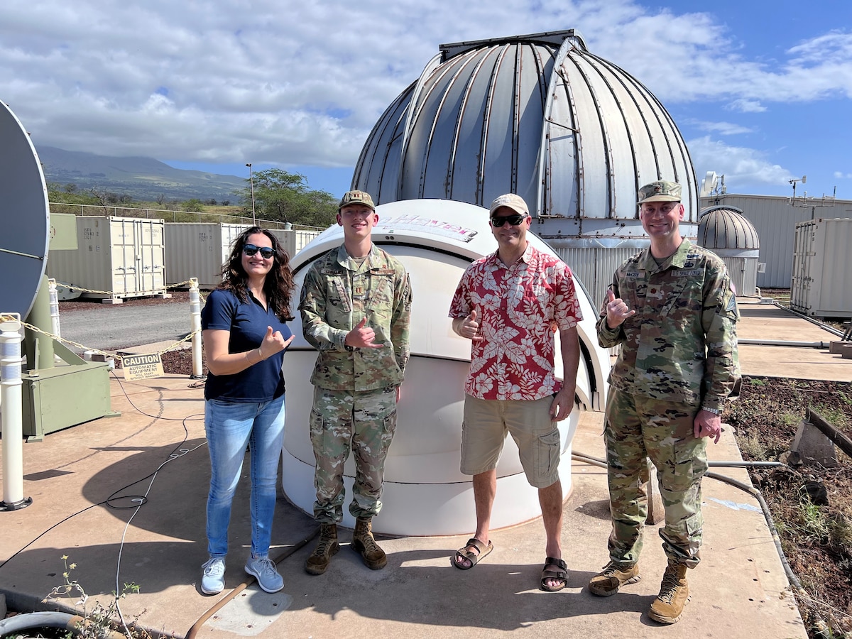 From left: Dr. Shadi Naderi, Air Force Research Laboratory research scientist and STEM technical lead; Capt. Charles Schramka, Air Force Research Laboratory research scientist; Scott Hunt, technical director for the Air Force Supercomputing and Optical Maui site; and Maj. Keegan McCoy, research flight commander for 15th Space Surveillance Squadron and branch chief for AFRL’s Directed Energy Directorate, stand in front of the Aloha telescope in commemoration of the outreach program’s 10-year anniversary, March 29, 2024.The astronomy outreach program has reached 6,000 students and 175 teachers over the last two years with the capability to view the moon and other objects in space. (U.S. Air Force photo / Shadi Naderi)