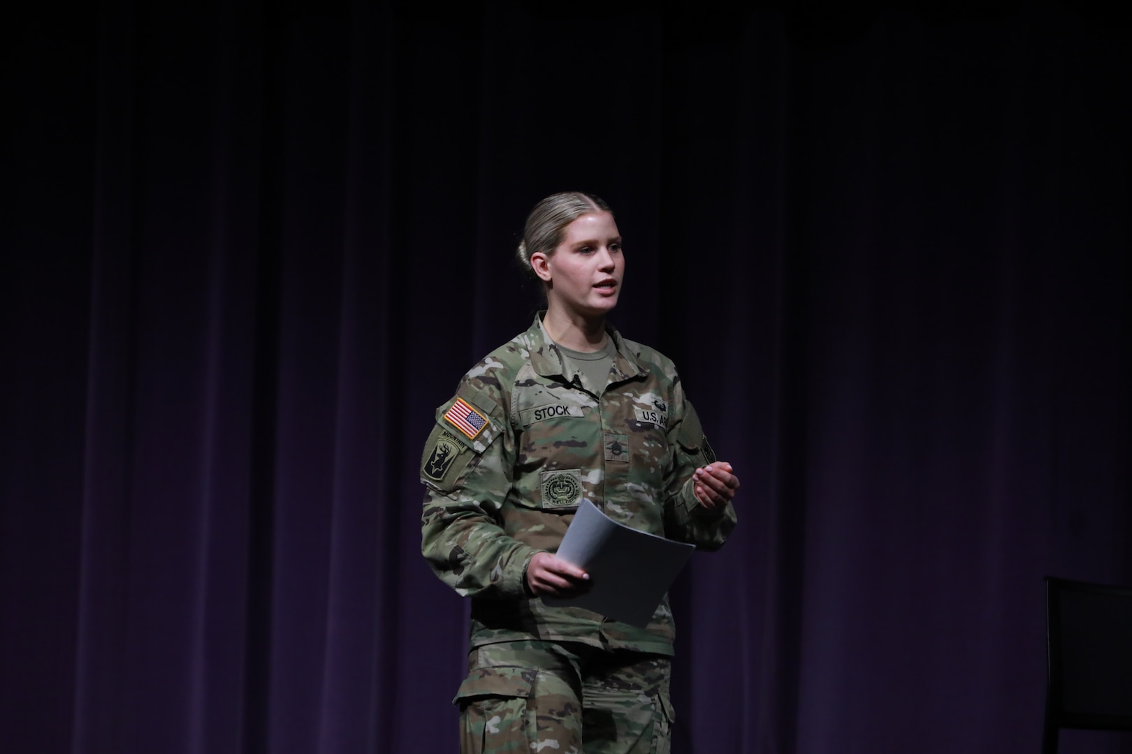 Staff Sgt. Amanda Stock, a Parenthood, Pregnancy, and Postpartum Program course advisor, presents a slideshow on mentorship to attendees of the Wisconsin Army National Guard's first ever Women's Symposium, March 29, 2024. The events focus was on reinforcing the organization's commitment to gender equality and empowering leaders, women, and allies to advocate for one another. (U.S. National Guard photo by Staff Sgt. Amber Peck)