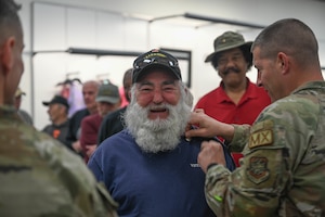 A veteran receives a pin.