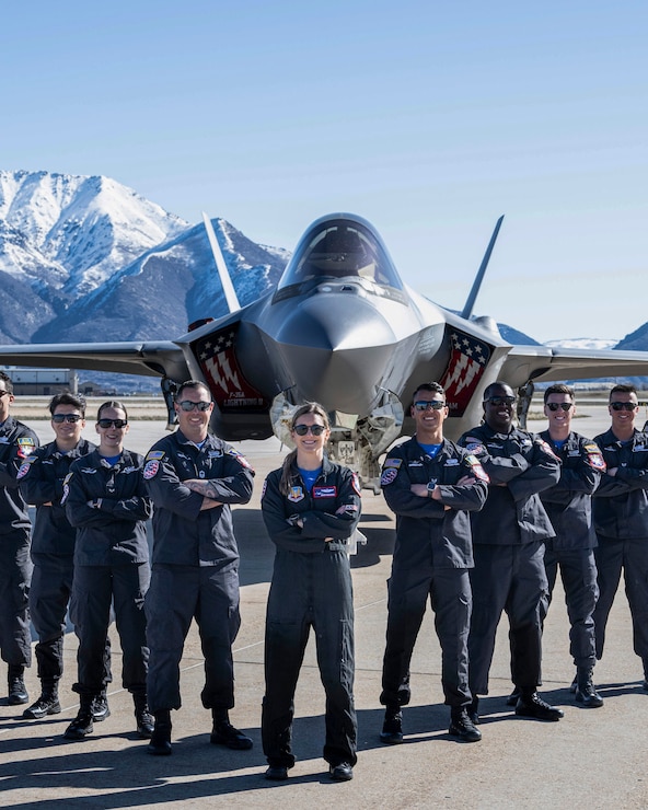 A photo of an F-35 crew chief standing in front of a jet