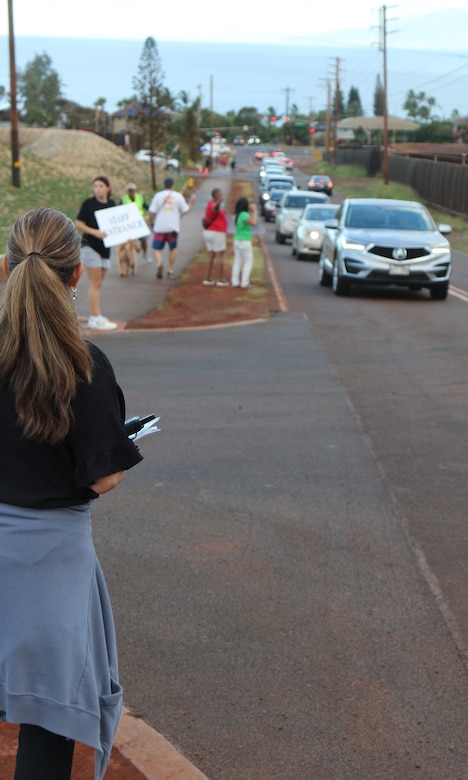 U.S. Army Corps of Engineers, Recovery Field Office Commander Col. Eric Swenson is joined by parents, community members and passersby to welcome back students as they were dropped off for their first day of school at the new King Kamehameha III Elementary School temporary campus installed by USACE. Swenson waved at smiling kids and parents thrilled to get to this milestone in the recovery process.