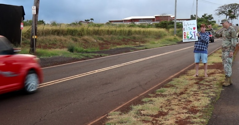 U.S. Army Corps of Engineers, Recovery Field Office Commander Col. Eric Swenson is joined by parents, community members and passersby to welcome back students as they were dropped off for their first day of school at the new King Kamehameha III Elementary School temporary campus installed by USACE. Swenson waved at smiling kids and parents thrilled to get to this milestone in the recovery process.