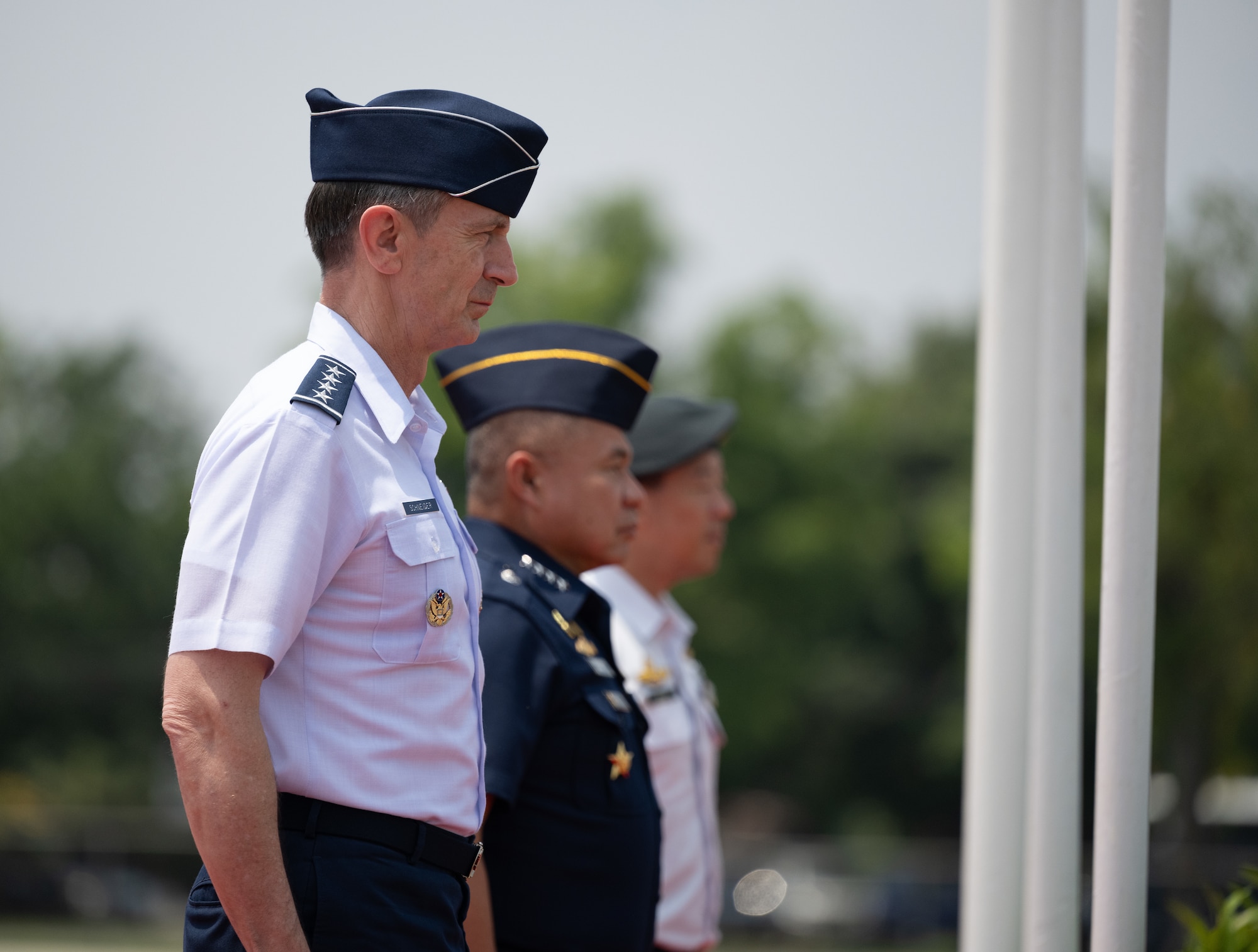 U.S. Air Force Gen. Kevin Schneider, Pacific Air Forces commander, attends the closing ceremony for Cope Tiger 2024 alongside Royal Thai Air Force Air Chief Marshal Punpakdee Pattanakul, Commander-in-Chief, and Republic of Singapore Air Force Brig. Gen. Kelvin Fan, Chief of Air Force, at Korat Royal Thai Air Force Base, Thailand, March 29, 2024. Through trilateral training, we work together to promote interoperability, thus furthering our investments and strengthening our relationships. (U.S. Air Force photo by Tech. Sgt. Hailey Haux)
