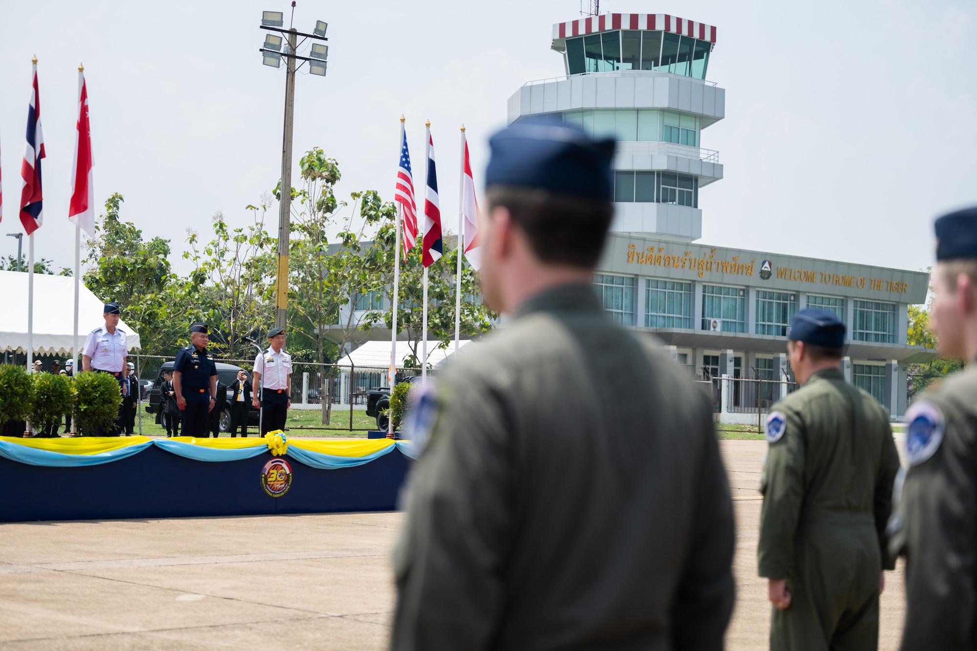 U.S. Air Force Gen. Kevin Schneider, Pacific Air Forces commander, attends the closing ceremony for Cope Tiger 2024 alongside Royal Thai Air Force Air Chief Marshal Punpakdee Pattanakul, Commander-in-Chief, and Republic of Singapore Air Force Brig. Gen. Kelvin Fan, Chief of Air Force, at Korat Royal Thai Air Force Base, Thailand, March 29, 2024. This year marked the first time 5th generation aircraft participated in the exercise—F-35A Lightning IIs from Eielson Air Force Base, Alaska joined F-16C Fighting Flacons from Kunsan Air Base, Republic of Korea. (U.S. Air Force photo by Tech. Sgt. Hailey Haux)