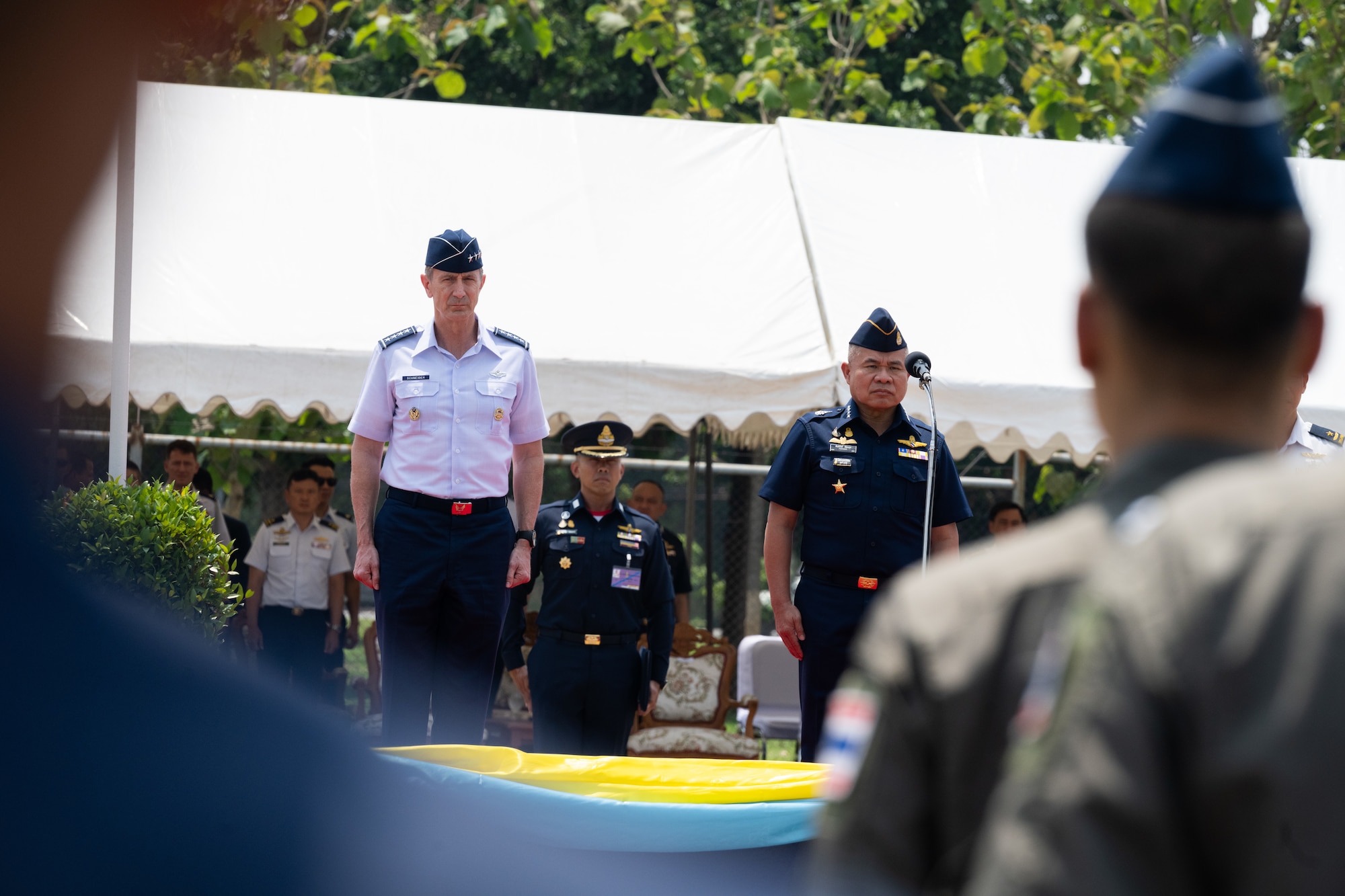 U.S. Air Force Gen. Kevin Schneider, Pacific Air Forces commander, attends the closing ceremony for Cope Tiger 2024 alongside Royal Thai Air Force Air Chief Marshal Punpakdee Pattanakul, Commander-in-Chief, at Korat Royal Thai Air Force Base, Thailand, March 29, 2024. During the exercise, many Airmen had the chance to go to a local school to play games with students while medical professionals from the Royal Thai Air Force and Republic of Singapore Air Force rendered care to locals with support from the U.S. Air Force medical team. (U.S. Air Force photo by Tech. Sgt. Hailey Haux)