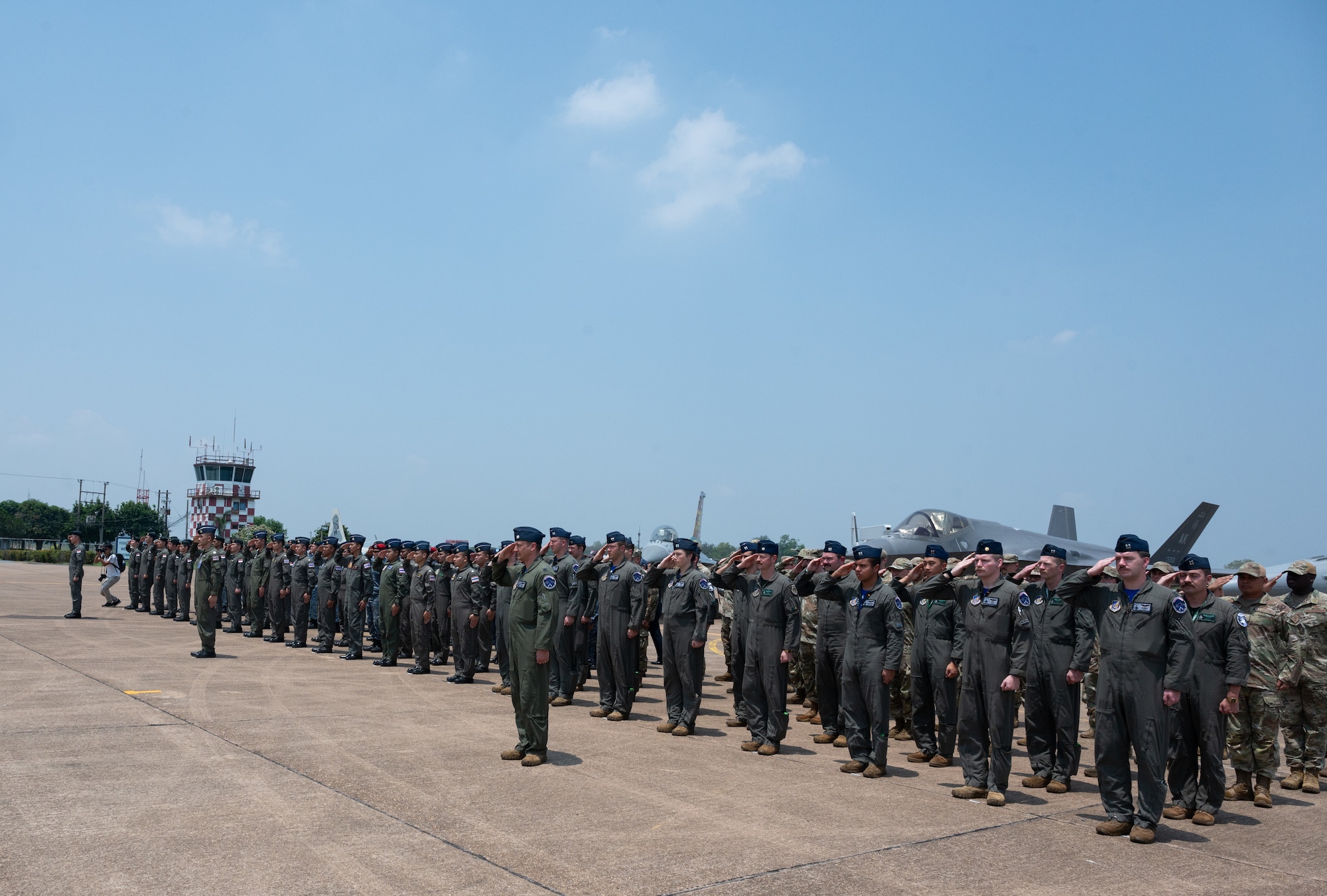Airmen from the Royal Thai Air Force, Republic of Singapore Air Force and U.S. Air Force stand in formation during the closing ceremony for Cope Tiger 2024 at Korat Royal Thai Air Force Base, Thailand, March 29, 2024. Exercises like these enhance capability and interoperability, while strengthening trust between like-minded nations to ensure the air, maritime, cyber, and space domains remain open to all nations. (U.S. Air Force photo by Tech. Sgt. Hailey Haux)