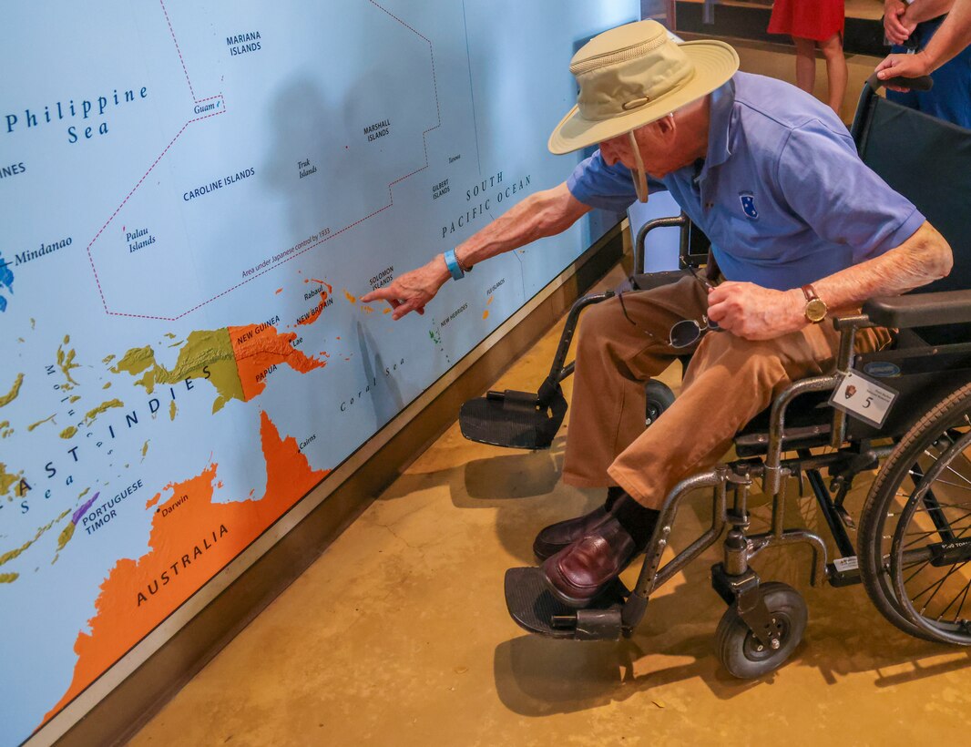Dr. Stanley Allen, a U.S. Army WWII veteran, points to an island he served on during the war on a map at the Pearl Harbor National Memorial (U.S. National Park Service) in Honolulu, Hawaii, March 19, 2024.