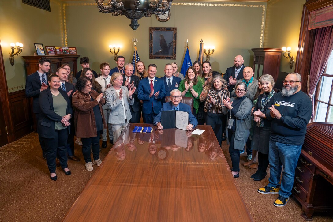 Gov. Tony Evers signs legislation into law changing the Wisconsin National Guard tuition grant program April 14 at his office in the state capitol. Under the changes, the Department of Military Affairs pays participating universities directly at the beginning of the semester, rather than reimbursing National Guard students at the end of each semester. Other changes include when students can apply for the grant and how satisfactory academic progress is determined. Greg Anderson photo