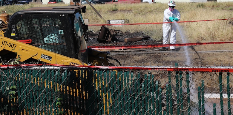 A U.S. Army Corps of Engineers contractor applies water to the ground of a commercial property while debris is being staged for removal during Phase 2 debris removal operations March 22, 2024, in Lahaina, Hawaii. This was the first commercial property debris removal operation for commercial property impacted by the Aug. 8, 2023, wildfires. (USACE photo by Edward Rivera)