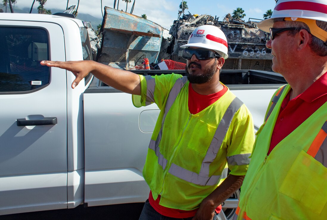 U.S. Army Corps of Engineers quality assurance specialist Jubbar Arshad (left), of the Rock Island District, monitors vessel debris removal in Lahaina, Hawai‘i, Jan. 27. To ensure debris removal operations are conducted safely there is significant coordination and safety planning between USACE and the contractor performing the work. USACE is overseeing the debris removal mission under a Federal Emergency Management Agency assigned mission, which is part of a coordinated effort with the Hawai‘i Emergency Management Agency, Maui County and the U.S. Environmental Protection Agency to clean up areas of the island affected by the Aug. 8, 2023, wildfires. (USACE Photo by Robert DeDeaux)