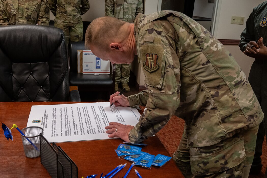 Brig. Gen. Derek Salmi, 60th Air Mobility Wing commander, signs this year’s Month of the Military Child, Autism Awareness Month and Child Abuse Prevention Month proclamation