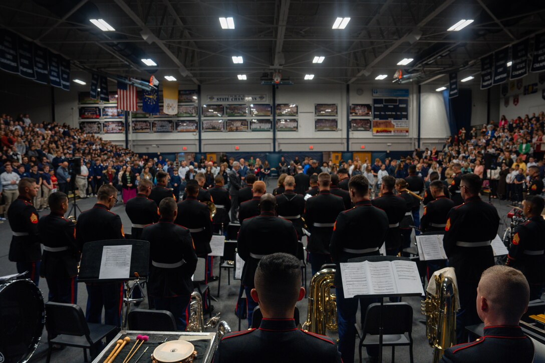 U.S. Marines assigned to Marine Band San Diego, bow their heads in prayer at Lafayette Central Catholic High School in Lafayette, Indiana, March 26, 2024. Marine Band San Diego's performances at high schools nationwide allow them to connect with and inspire students and their communities while also promoting the opportunities the Marine Corps has to offer. (U.S. Marine Corps photo by Lance Cpl. Francisco Angel)