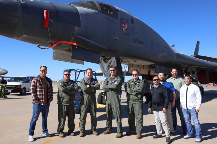 Group of men standing in front B-1B aircraft