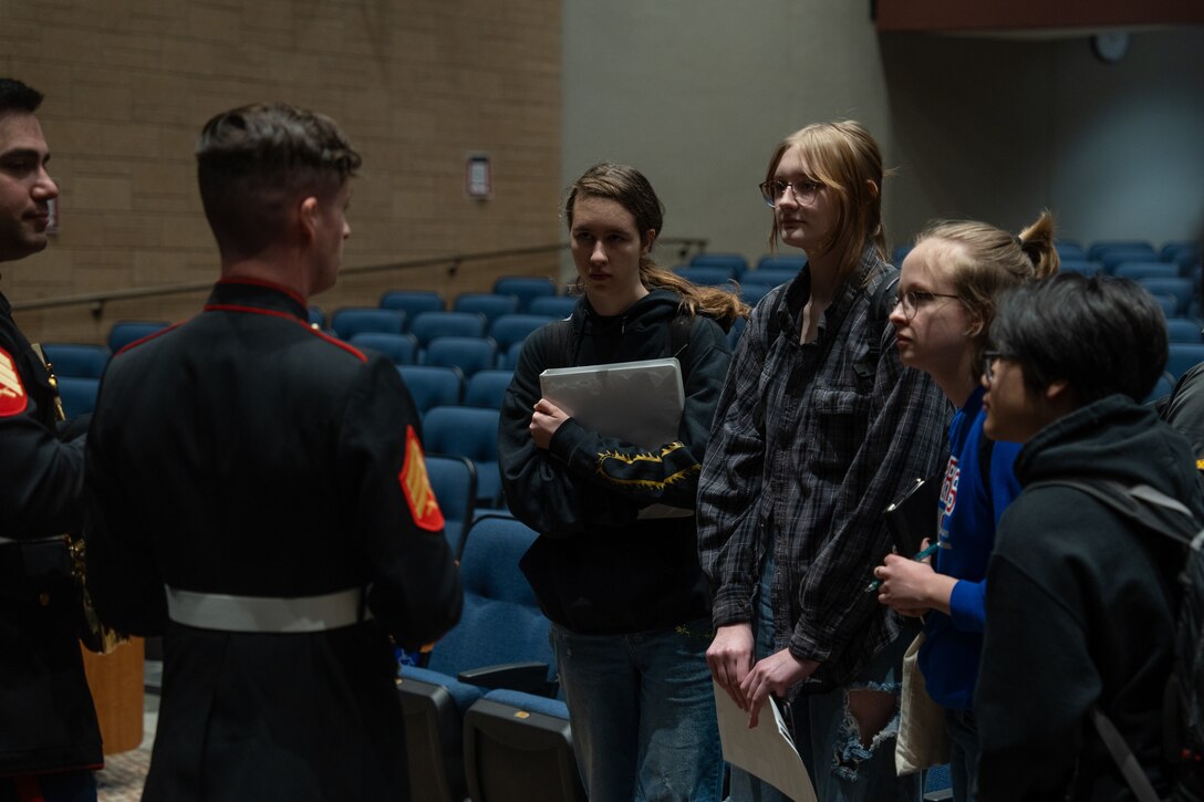 U.S. Marines assigned to Marine Band San Diego speak with students from Simley High School in Inver Grove Heights, Minnesota, March 19, 2024. Marine Band San Diego's performances at high schools nationwide allow them to connect with and inspire students and their communities while also promoting the opportunities the Marine Corps has to offer. (U.S. Marine Corps photo by Lance Cpl. Francisco Angel)