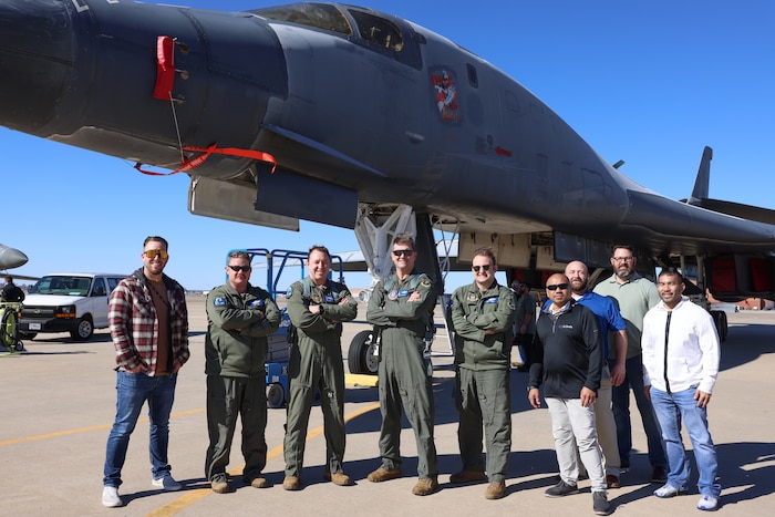 Group of men standing in front B-1B aircraft