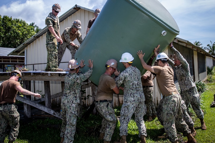 WEWAK, Papua New Guinea (Oct. 12, 2023) – Pacific Partnership 2023 Seabees remove a water container during a renovation project at Mongniol Primary School during Pacific Partnership 2023, Oct. 12.  Now in its 18th year, Pacific Partnership is the largest annual multinational humanitarian assistance and disaster relief preparedness mission conducted in the Indo-Pacific. (U.S. Navy photo by Chief Mass Communication Specialist Eric Chan)