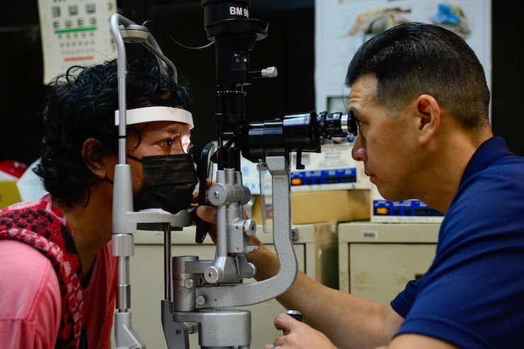 U.S. Navy Cmdr. Gabe Valerio, from San Diego, uses a slit lamp to check a Palauan patient's eyes during an ophthalmology post-op consultation at Belau National Hospital during Pacific Partnership 2024-1 in Koror, Palau, Jan. 5, 2024. Pacific Partnership, now in its 19th iteration, is the largest multinational humanitarian assistance and disaster relief preparedness mission conducted in the Indo-Pacific and works to enhance regional interoperability and disaster response capabilities, increase security stability in the region, and foster new and enduring friendships. (U.S. Navy photo by Mass Communication Specialist 2nd Class Celia Martin)