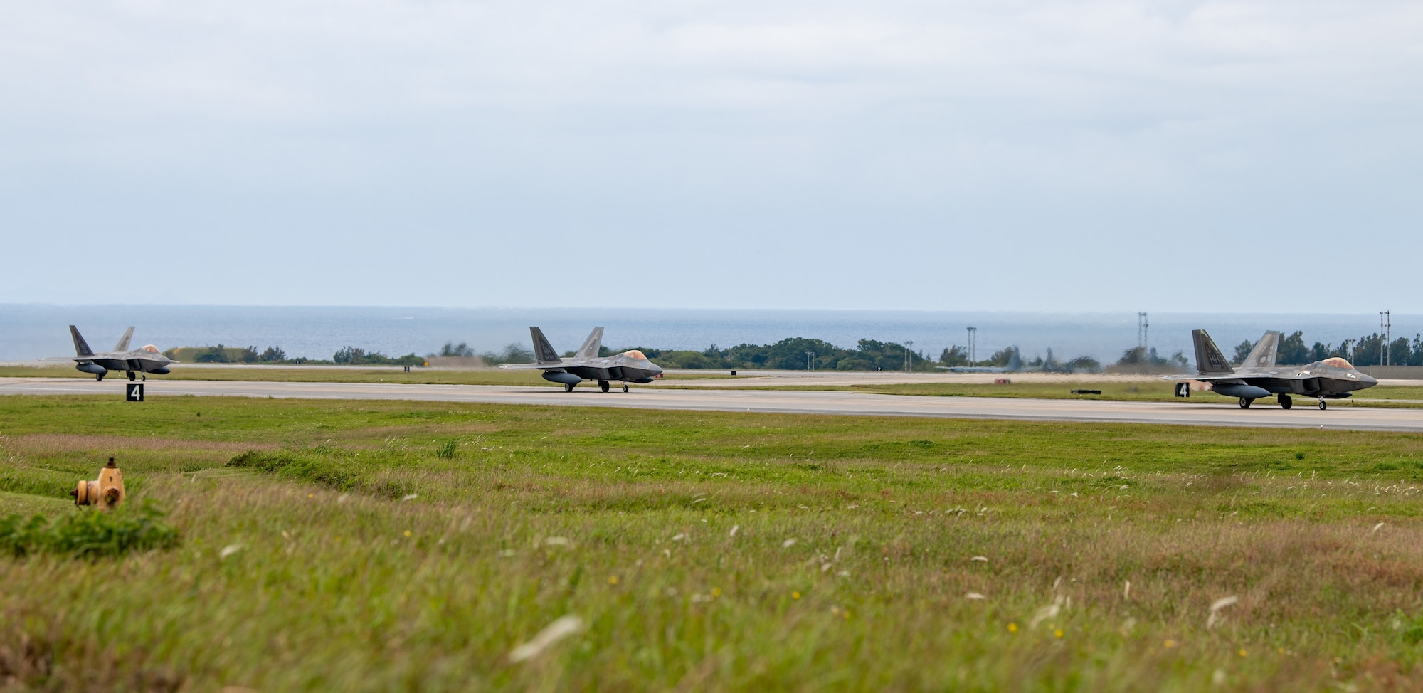 U.S. Air Force F-22A Raptors, operated by the 199th and 19th Fighter Squadrons, land at Kadena Air Base.