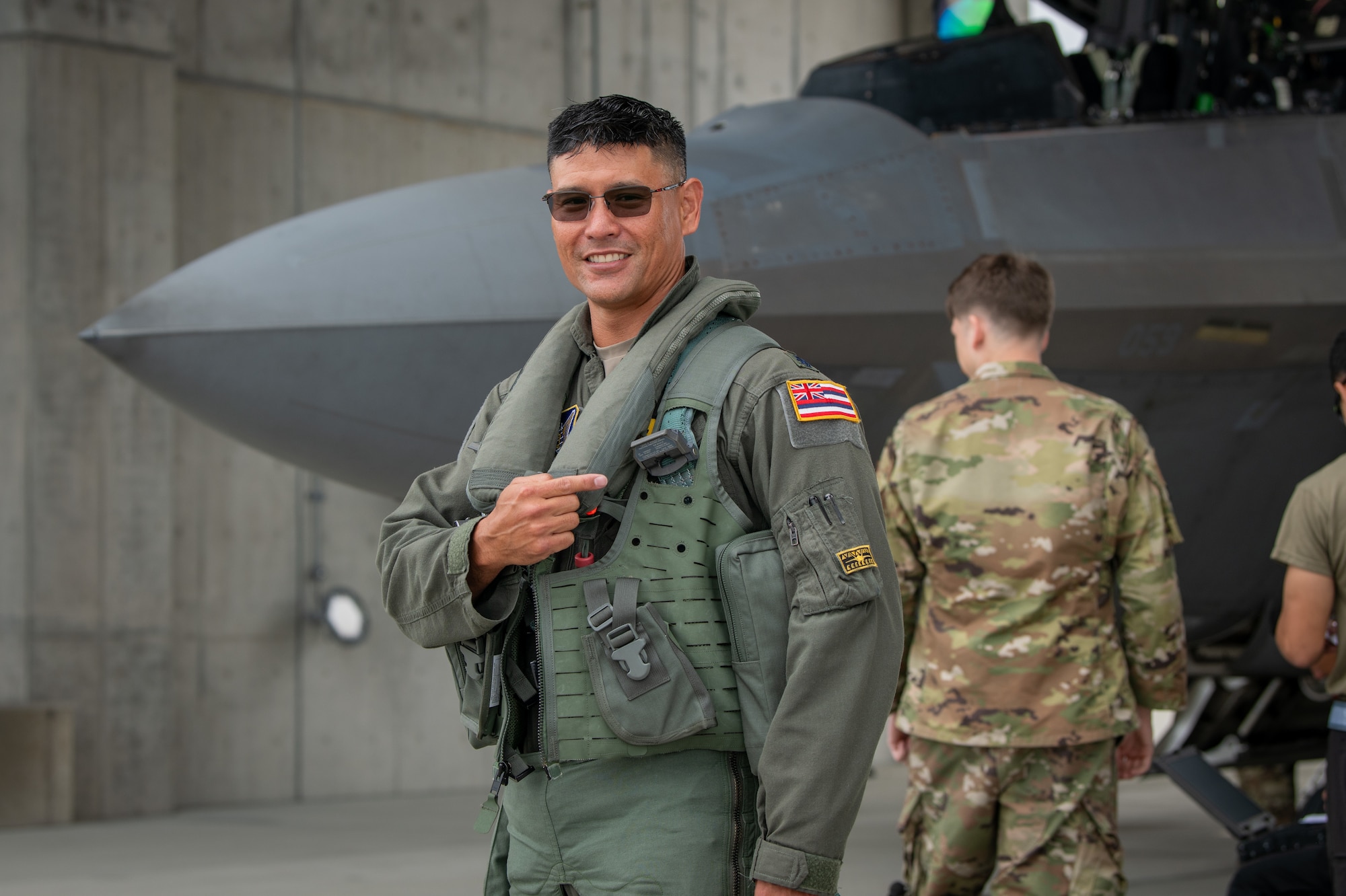 A U.S. Air Force pilot assigned to the Hawaiian Raptors Squadron, comprised of the 199th and 19th Fighter Squadrons, poses for a photo at Kadena Air Base.