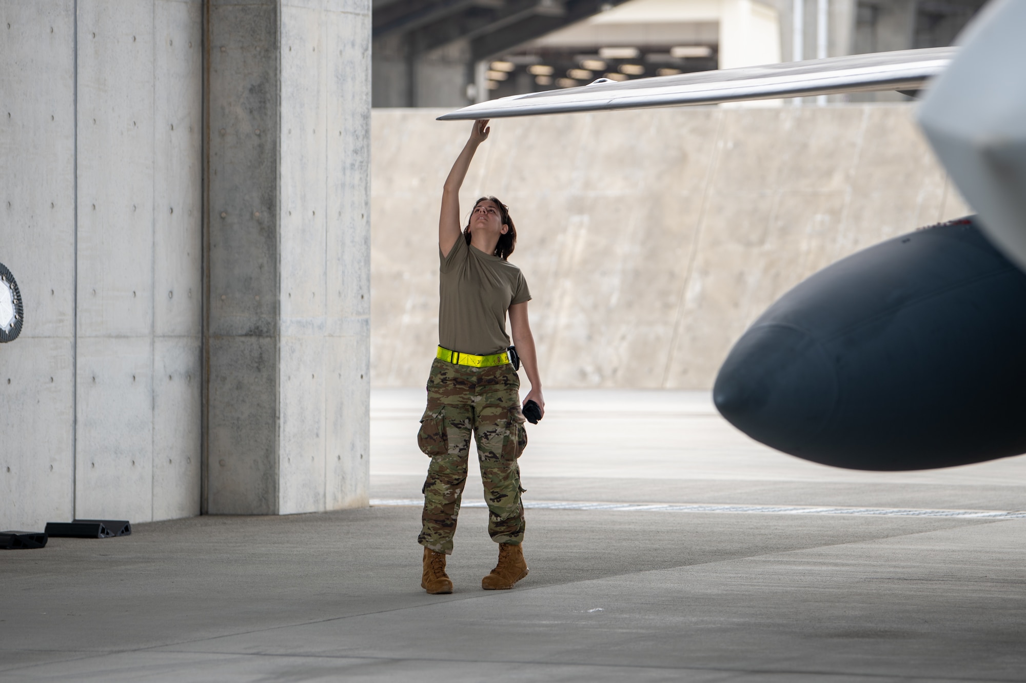 A U.S. Air Force crew chief assigned to the 19th Aircraft Maintenance Unit conducts post flight checks on an F-22A Raptor operated by the 199th and 19th Fighter Squadrons at Kadena Air Base.