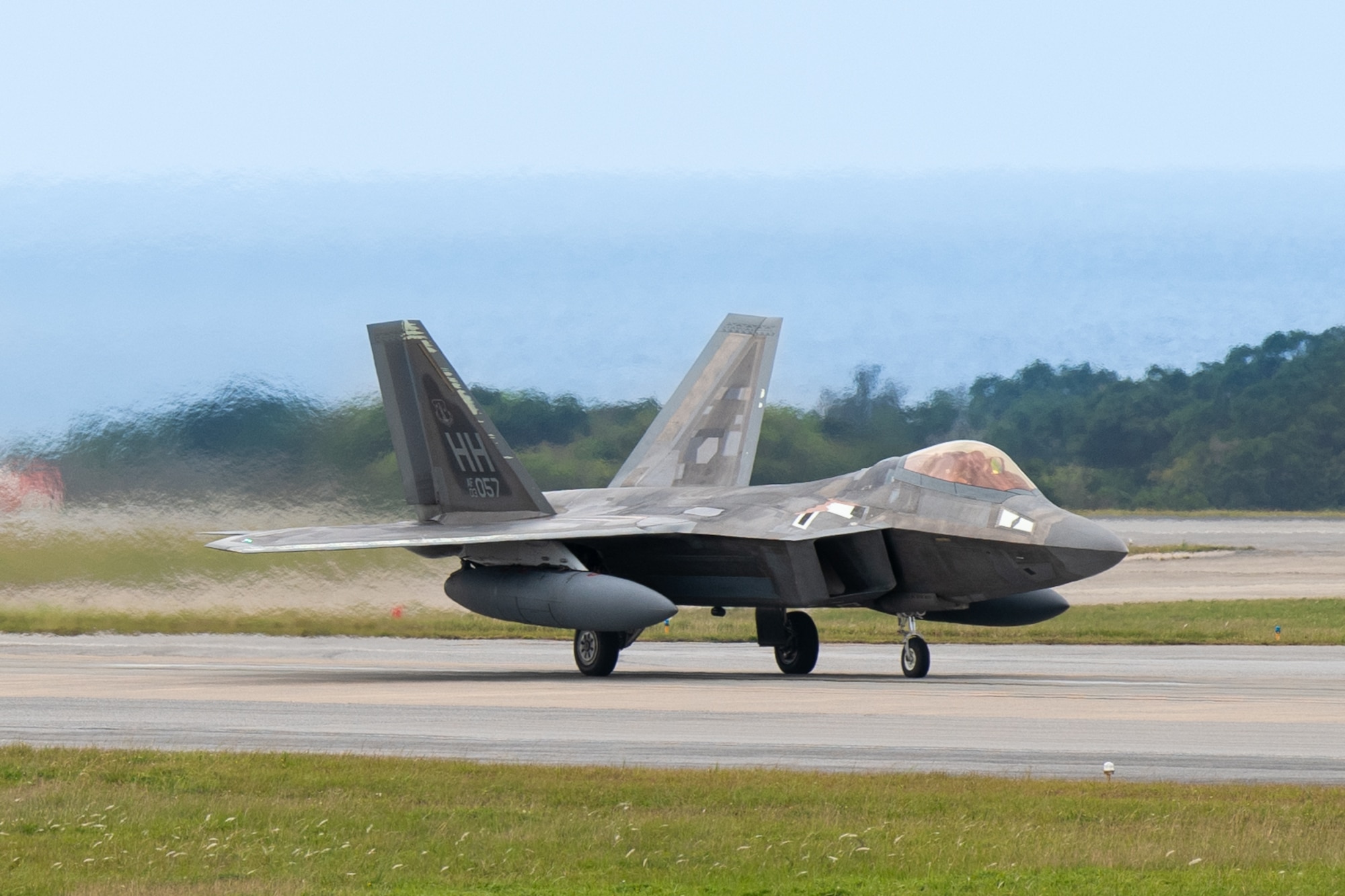 A U.S. Air Force F-22A Raptor, operated by the 199th and 19th Fighter Squadrons, lands at Kadena Air Base.