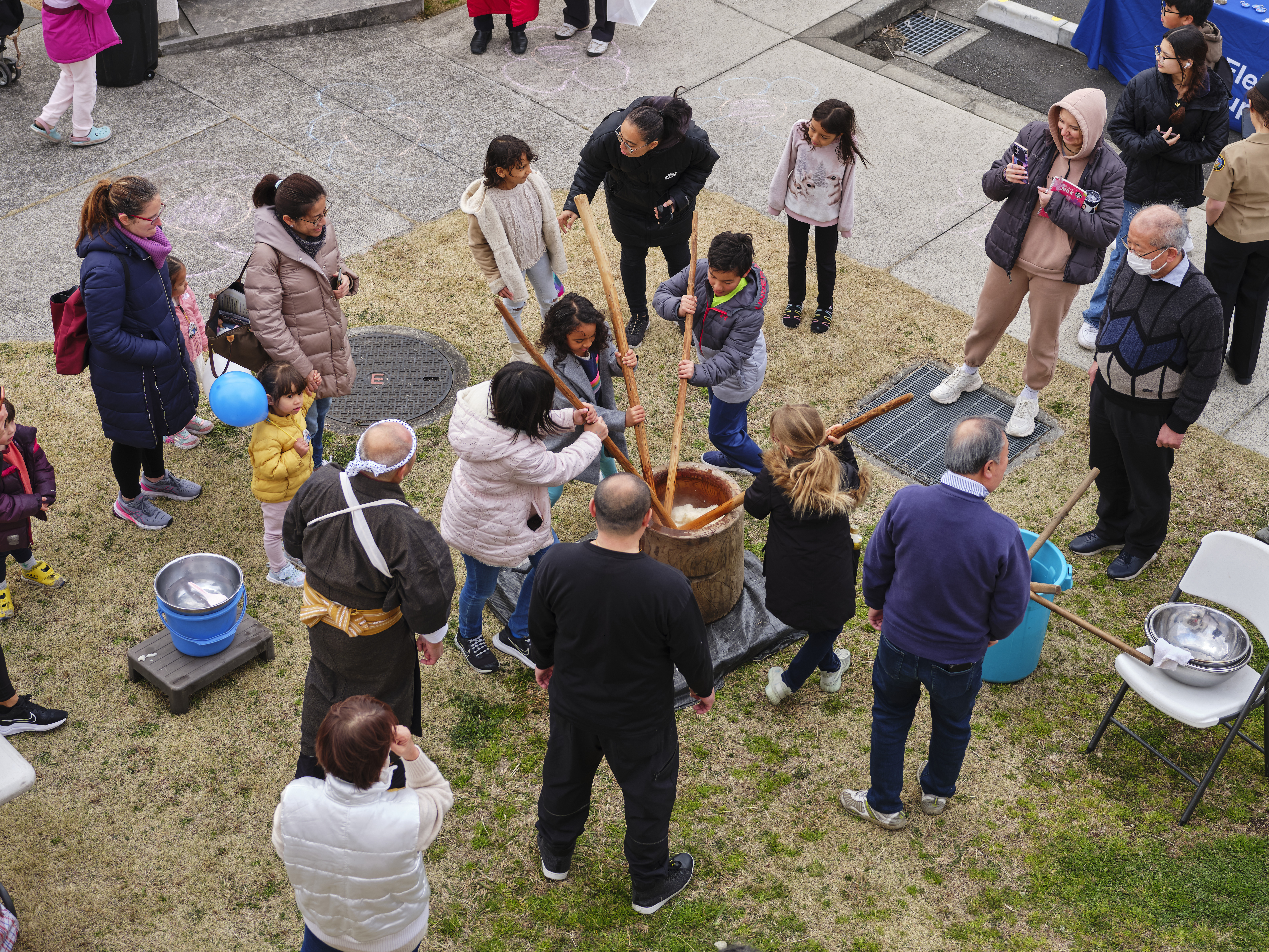 Children from the Ikego community participate in a mochi pounding with members from the Japan-America Society of Zushi in the Ikego Community Outreach Fair Spring to Spring March 2, 2024 in Ikego Housing Area.