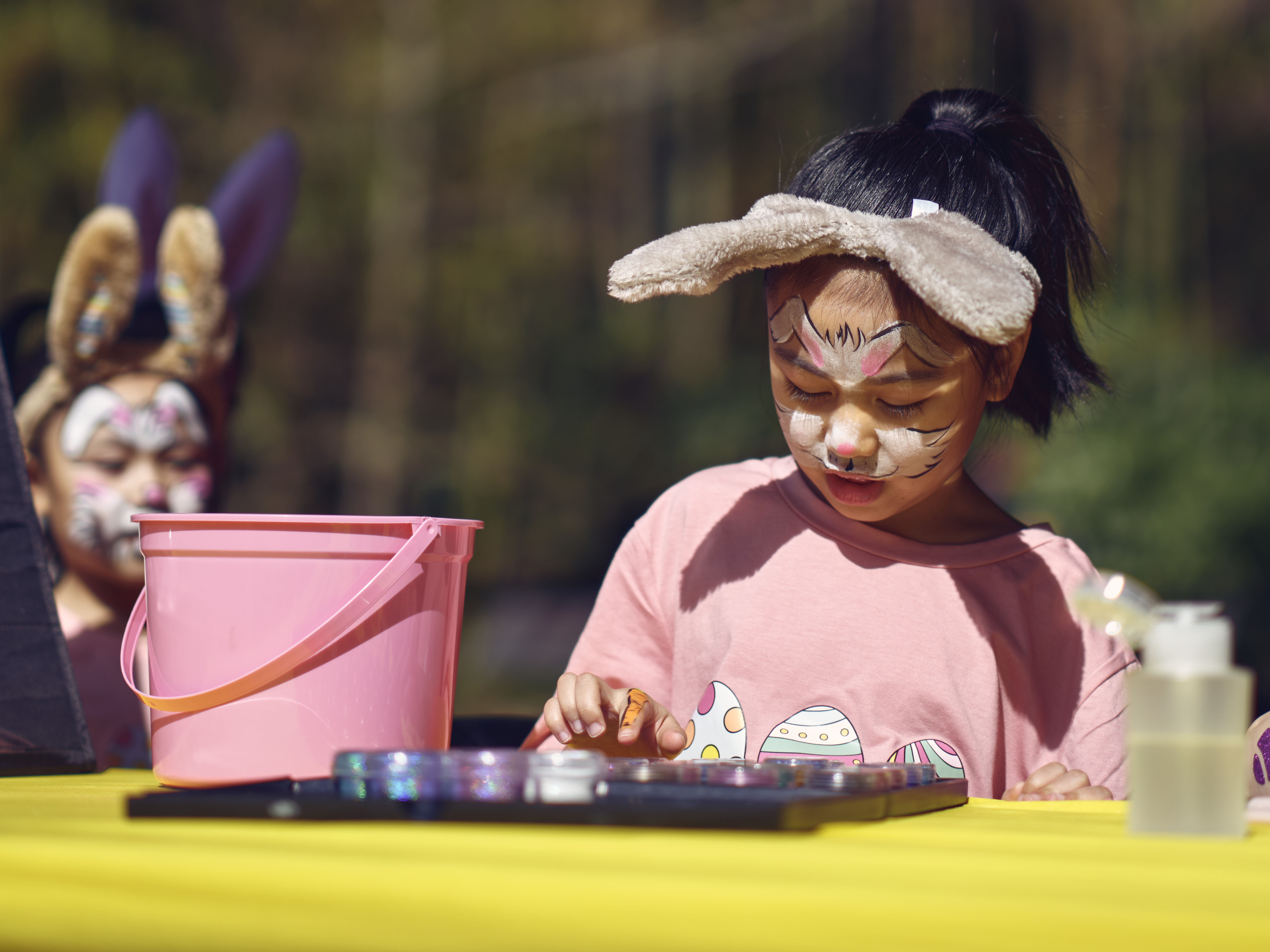 A child picks out paint colors for a temporary hand tattoo at Commander, Fleet Activities Yokosuka's Ikego West Valley Campground March 31, 2024 during Egg'Stravaganza.