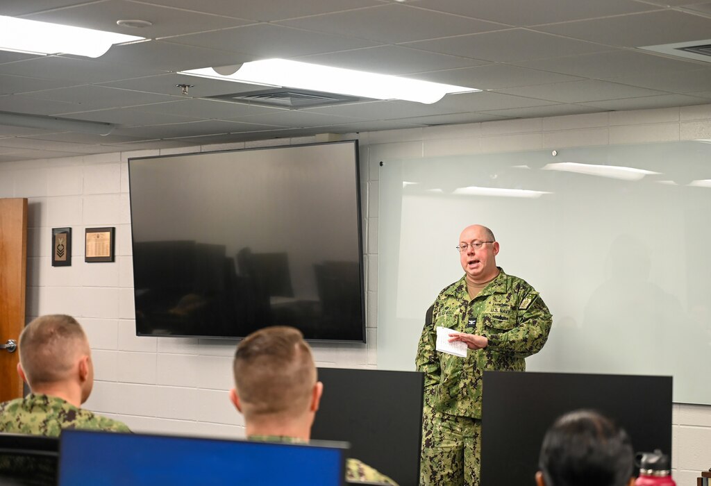 While visiting the Center for Information Warfare Training, Capt. Bryan Braswell, commander, Naval Information Warfighting Development Center, spoke to the graduating class of Cryptologic Warfare Officer Basic Course (CWOBC) students, on Corry Station, Apr. 3, 2024.