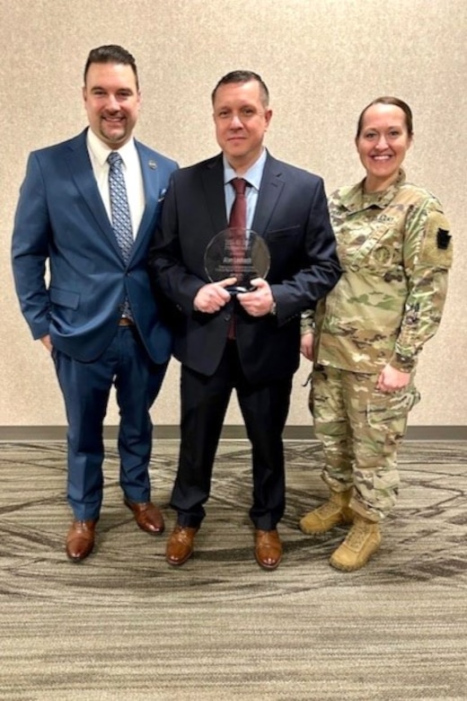 (Left to right) Nathan Smail, Internal Communications Specialist for Pittsburgh Regional Transit; Sgt. Allen Loskoch of the 128th Brigade Support Battalion; and Maj. Carolyn Prah, commander of the 128th BSB, pose for a photo during an awards ceremony in Pittsburgh, Pennsylvania, Feb. 23, 2024. This ceremony was to recognize Loskoch for his lifesaving actions while working for Pittsburgh Regional Transit in February 2024. (Courtesy Photo)