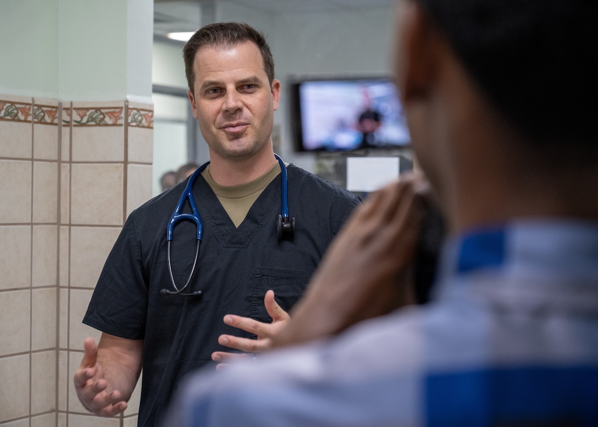 Image of an Airman treating a patient.
