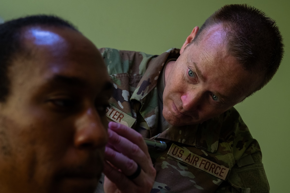 Image of an Airman treating a patient.