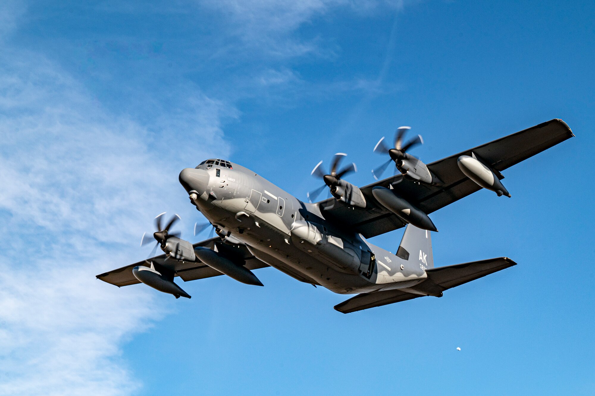 U.S. Air Force Airmen assigned to the 211th Rescue Squadron performs a precision drop over Smoky Hill Air National Guard Range, Kansas, March 26, 2024. Rescue Airmen from six different squadrons tested their accuracy of precision aerial cargo drops as part of the Rescue Rodeo. (U.S. Air Force photo by Airman 1st Class Leonid Soubbotine)
