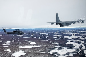 A 211th Rescue Squadron HC-130J Combat King II refuels a 210th Rescue Squadron HH-60G Pave Hawk during training at Joint Base Elmendorf-Richardson, Alaska, March 23, 2020. During a March 30, 2024, medical evacuation mission from JBER to near Ruby about 175 miles west of Fairbanks on the Yukon River, HC-130 refueling was necessary to extend the range of the HH-60.