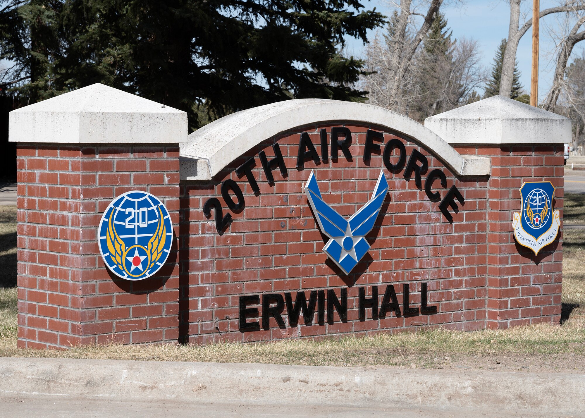 brick sign on grass, displaying 20th Air Force logo and Erwin Hall in black letters