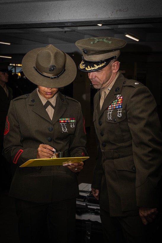 U.S. Marine Corps Lt. Col. James R. Smith, the commanding officer of 2nd Recruit Training Battalion, looks over the inspection sheet during the Hotel Company battalion commander inspection at Marine Corps Recruit Depot San Diego, California, April 3, 2024. The battalion commander’s inspection surveys new Marines knowledge, bearing, and attention to detail and is one of their last tests before graduating. (U.S. Marine Corps photo by Cpl. Sarah M. Grawcock)