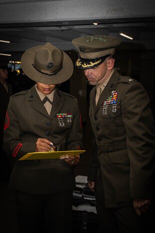 U.S. Marine Corps Lt. Col. James R. Smith, the commanding officer of 2nd Recruit Training Battalion, looks over the inspection sheet during the Hotel Company battalion commander inspection at Marine Corps Recruit Depot San Diego, California, April 3, 2024. The battalion commander’s inspection surveys new Marines knowledge, bearing, and attention to detail and is one of their last tests before graduating. (U.S. Marine Corps photo by Cpl. Sarah M. Grawcock)