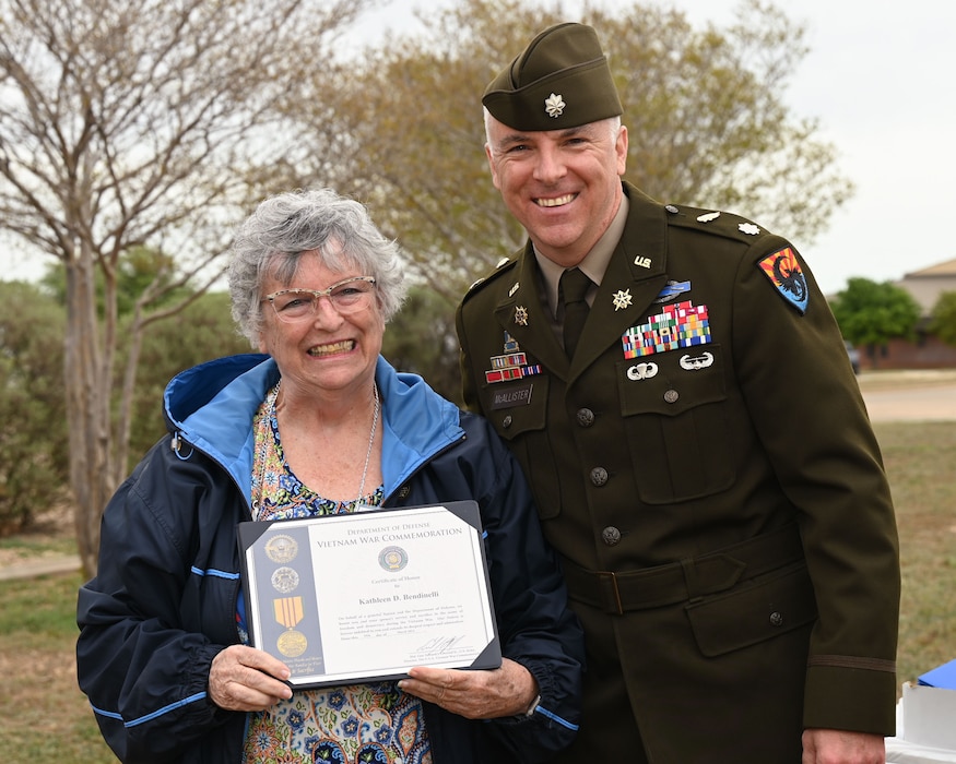 U.S. Army Lt. Col. John McAllister, 344th Military Intelligence Battalion commander, poses for a photo with Kathleen D. Bendinelli, the surviving spouse of Air Force Chief Master Sgt. Ed Bendinelli, during the 2024 National Vietnam War Veteran Memorial and Pinning Ceremony at the Weyandt-Eddy Memorial Plaza, Norma Brown Headquarters building, Goodfellow Air Force Base, Texas, March 29, 2024. The Vietnam War Veterans Recognition Act of 2017 was signed into law by 45th U.S. President Donald J. Trump, designating March 29 as National Vietnam War Veterans Day.