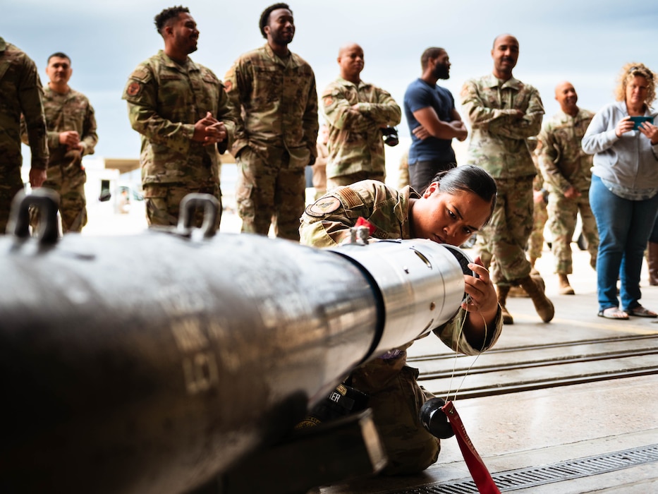 Senior Airman prepares a GBU-12 aerial laser-guided bomb to be loaded onto an F-35A Lightning II