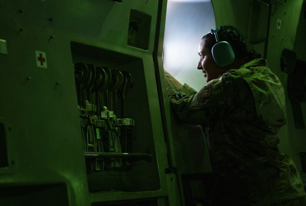 Air Force ROTC cadet takes a photo out the window of a C-17 Globemaster III