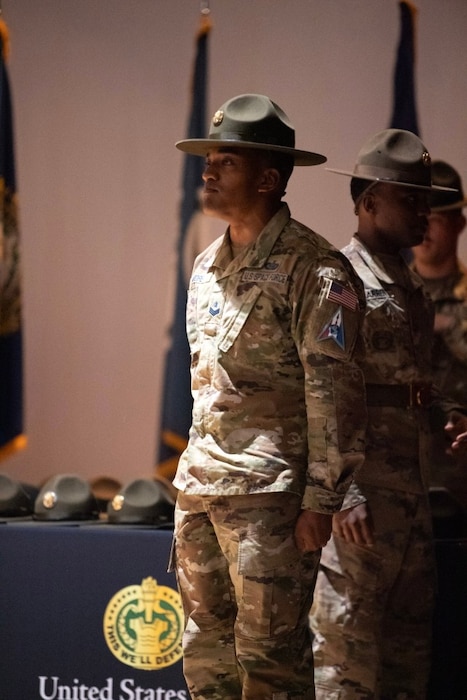 Sgt. Yuji R. Moore, a new graduate from the U.S. Army Drill Sergeant Academy's Class 006-24, waits to introduce himself and walk across the stage during a graduation ceremony at the U.S. Army Drill Sergeant Academy in Fort Jackson, S.C., April 3, 2024. Moore was one of first Guardians to graduate from the academy. (U.S. Army photo by Robert Timmons)