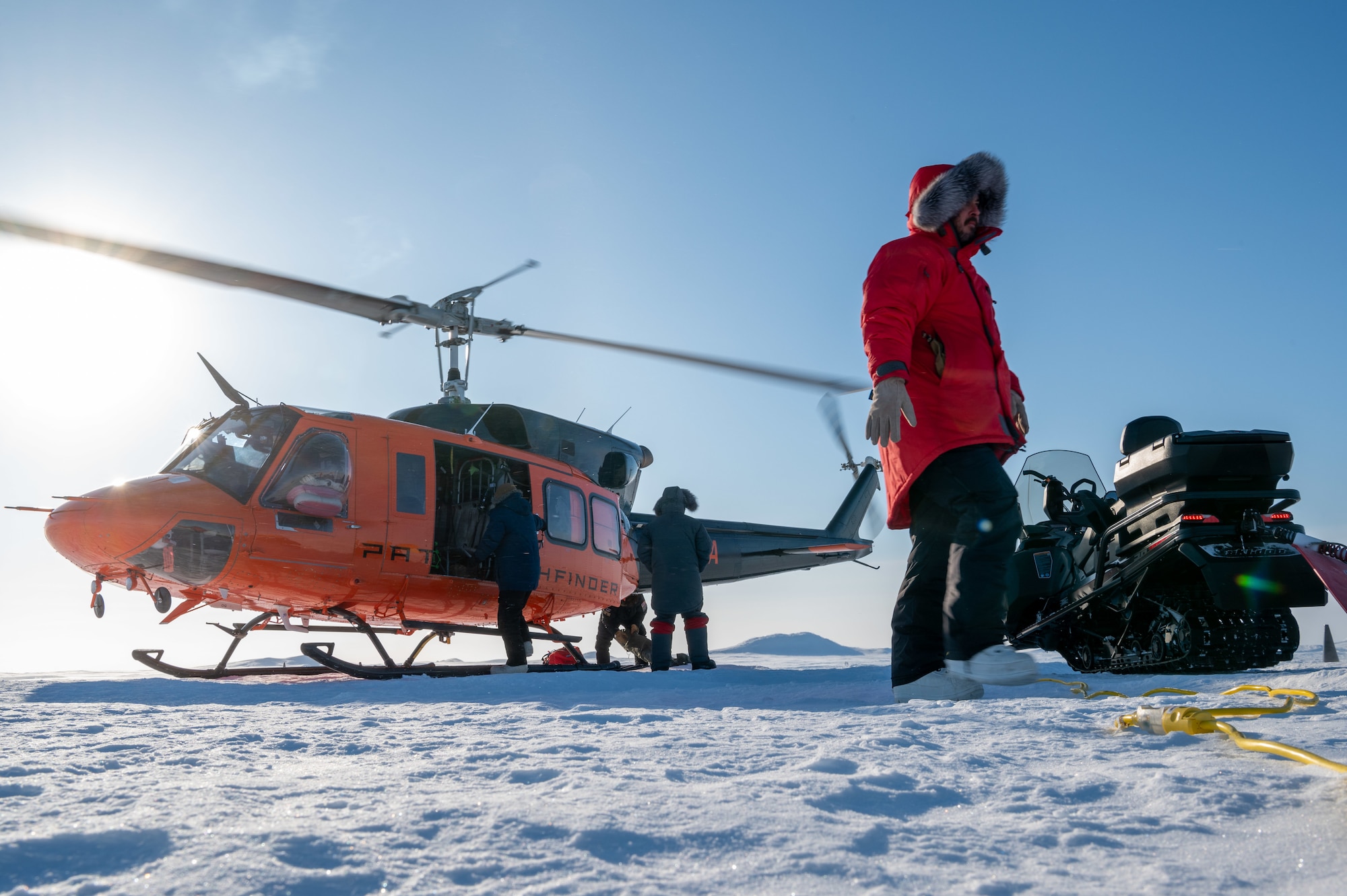 Personnel load equipment on helicopter during Operation Ice Camp.