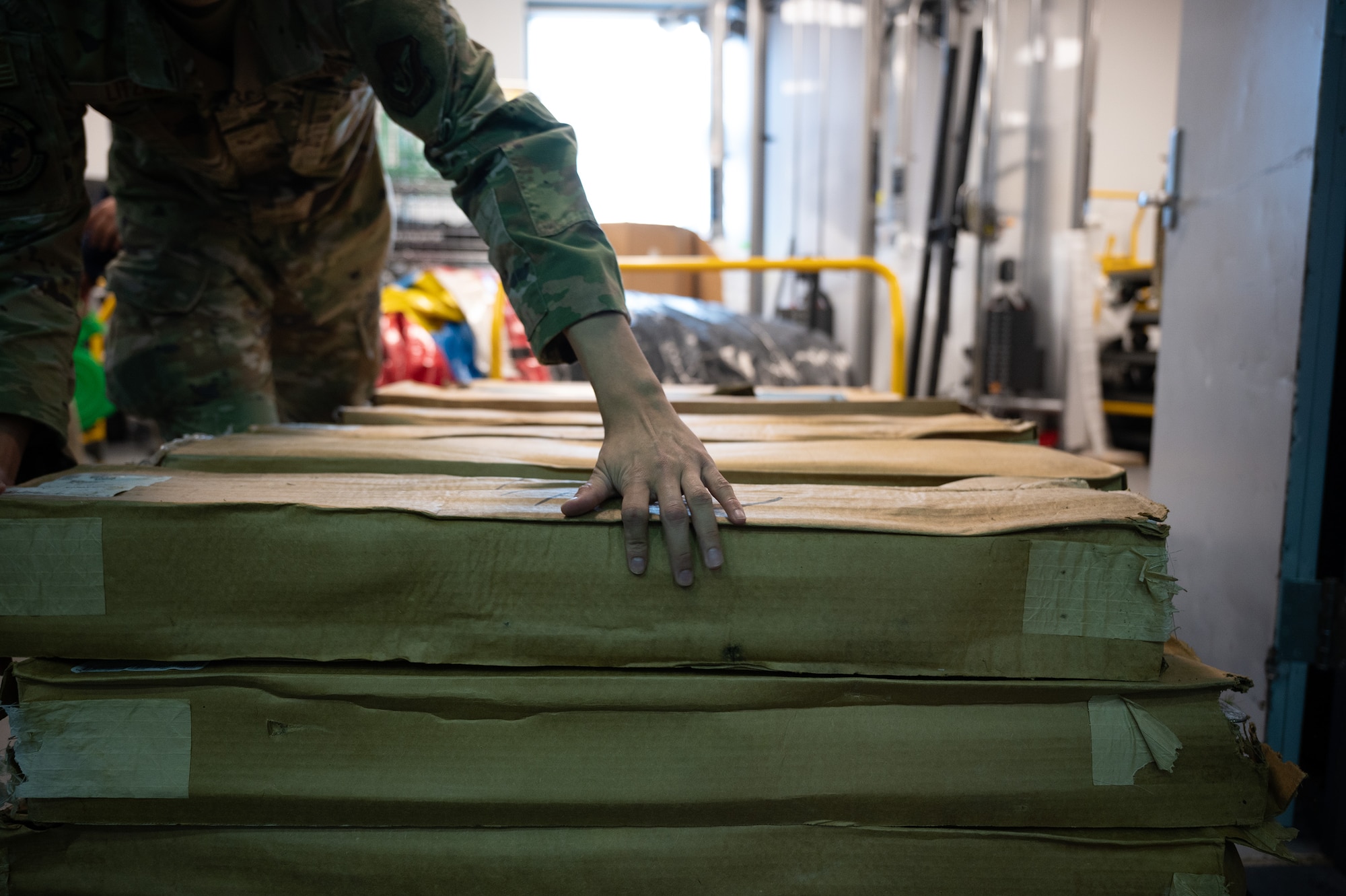 An Airman stacks cots during a beddown exercise.