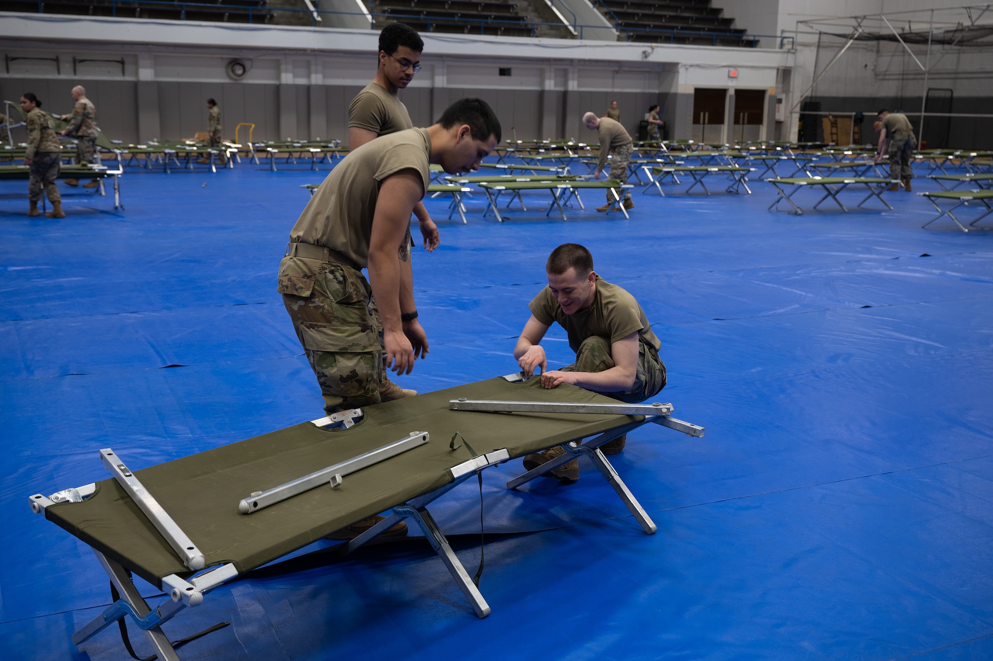 Airmen assemble cots during a beddown exercise.