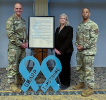 U.S. Army Maj. Gen. John V. Meyer III, the commanding general of the 1st infantry Division and Fort Riley, and Command Sgt. Maj. Clarence B. Raby, the 1st Infantry Division Special Projects Command Sergeant Major, stand with Barbara J. Garber, the 1st Inf. Div. lead Sexual Assault Response Coordinator, March 28, 2024, at Riley’s Community Center. Meyer, Raby and Garber signed the annual SAAPM proclamation. (U.S. Army photo by Lt. Col. Jefferson Grimes)